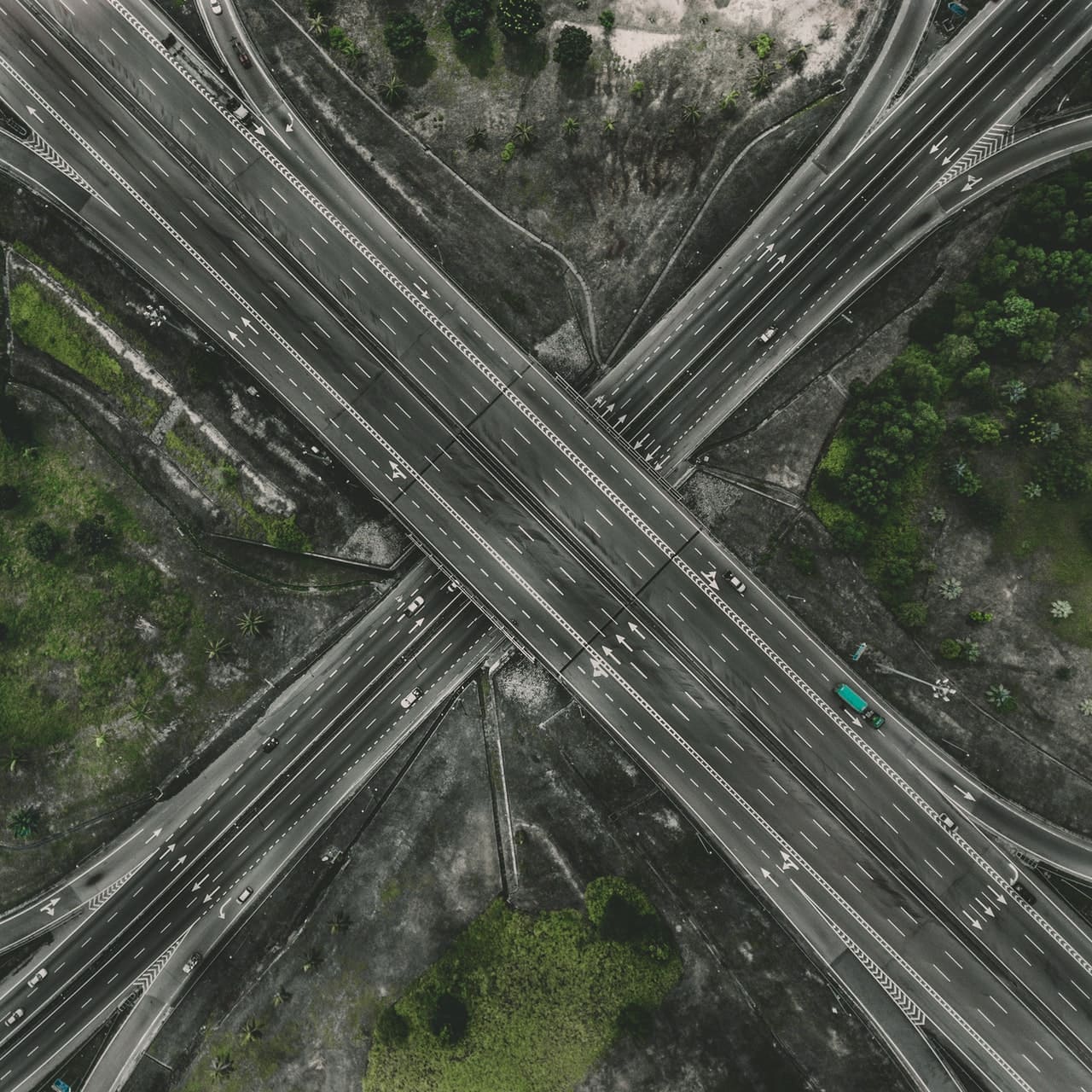Drone image of many roads and overpasses winding past each other with vehicles travelling on them.